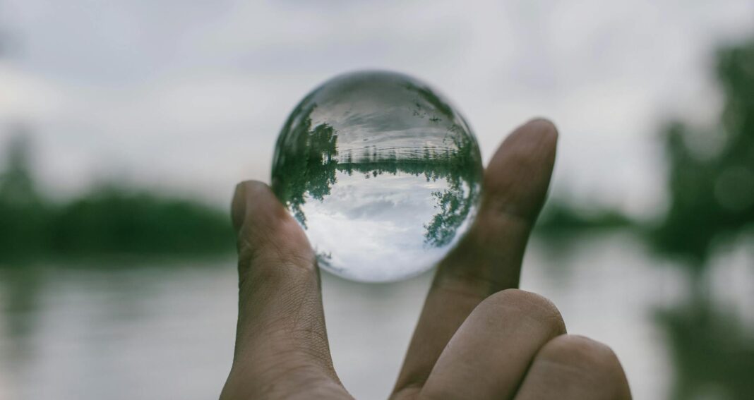 close up photography of person holding crystal ball