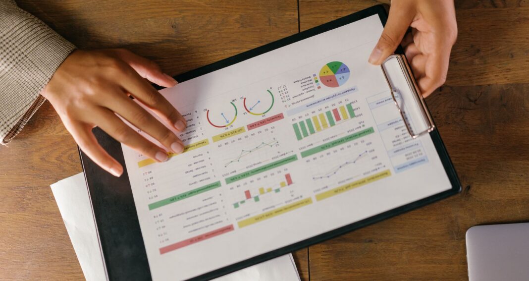 charts and graphs on paper on a clipboard